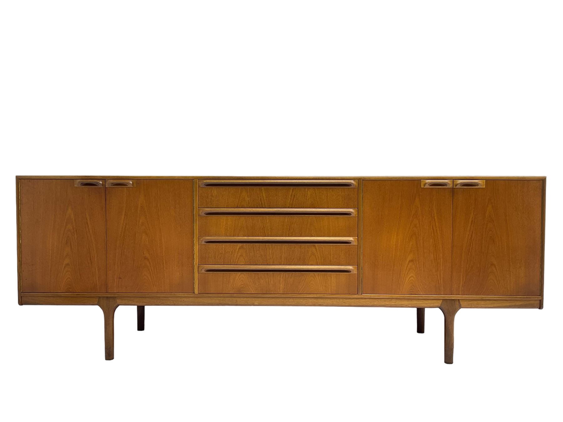 Tom Robertson for AH McIntosh & Co of Kirkaldy - mid-20th century teak sideboard, fitted with four central drawers, flanked by cupboard enclosing shelves and sliding tray, raised on cylindrical supports