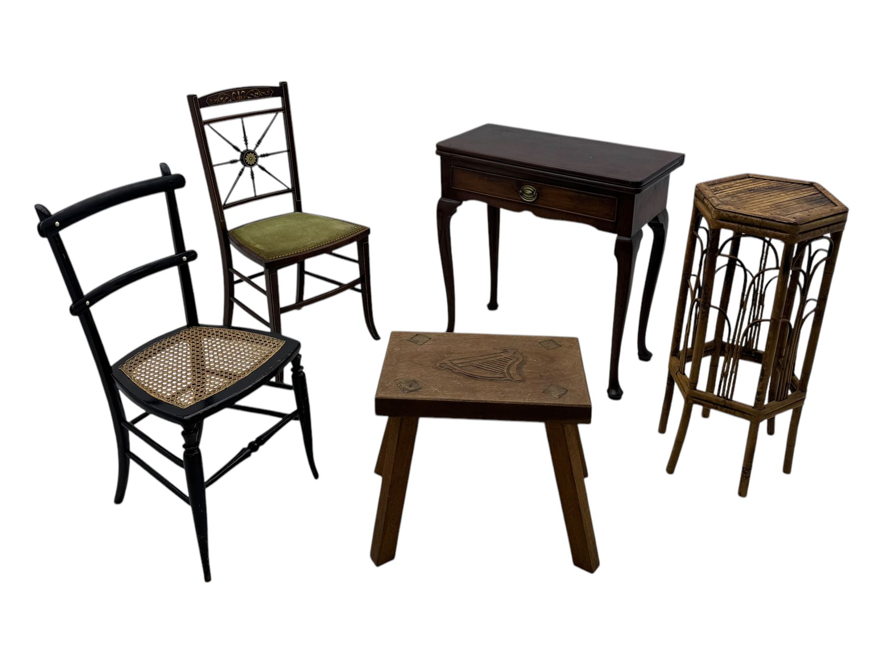 Late 19th century black-painted cane seat chair; early 20th century radial spindle-back chair with green upholstery; early 20th century mahogany single-drawer side table; mid-20th century carved wooden stool with harp motif; early 20th century hexagonal bamboo stand; two oval mirrors (7)