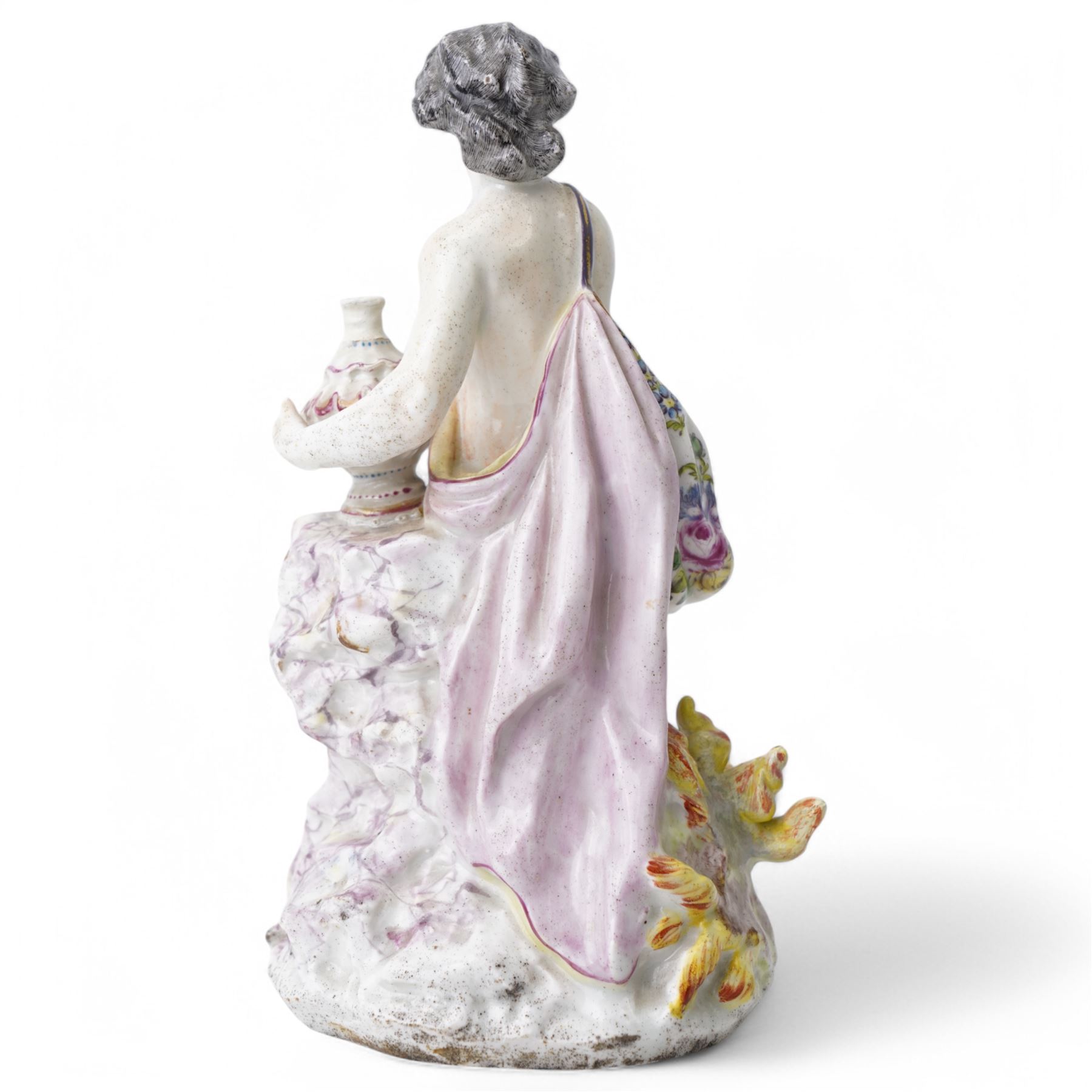 18th century possibly Staffordshire porcelain figure of Vulcan, adorned in classically draped robes, holding an urn and standing on a naturalistic base with volcanic flames H20cm