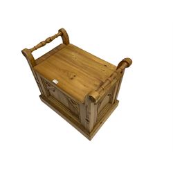 Gothic style pine stool with hinged box seat, decorated with flower head motifs, plinth base