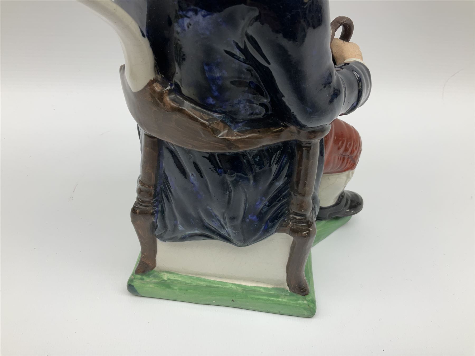 Early 20th century Staffordshire William Kent Squire toby jug, modelled seated upon a corner chair holding a jug of ale in his right hand, H28cm