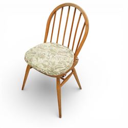 Ercol - elm dining chairs, a set of five comprising four side chairs and one '370' armchair, all with hoop backs formed with slender spindle splats, shaped solid elm seats, the armchair with curved out-swept arms, raised on splayed turned supports united by stretchers