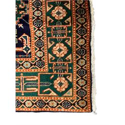 Small Persian indigo ground rug, the field decorated with Gilt motifs with trailing bead and stylised foliage, emerald green ground border decorated with geometric design and flower heads