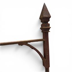 Georgian wrought iron single garden gate, pointed finial over strapwork cresting rail and arched profile with spearhead finials, the opposing side with scrollwork and hinged latch