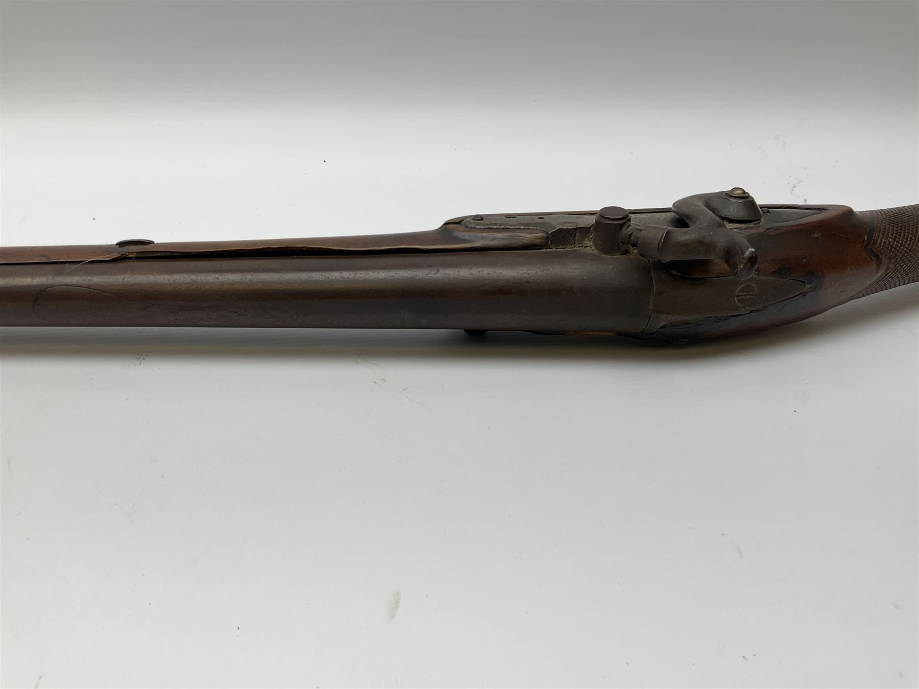 Early 19th century 15-bore flintlock converted to percussion cap fowling piece, the lock stamped T. Richards, walnut half stock with brass fittings including trigger guard with pineapple finial and 91cm barrel with ramrod under L129cm overall