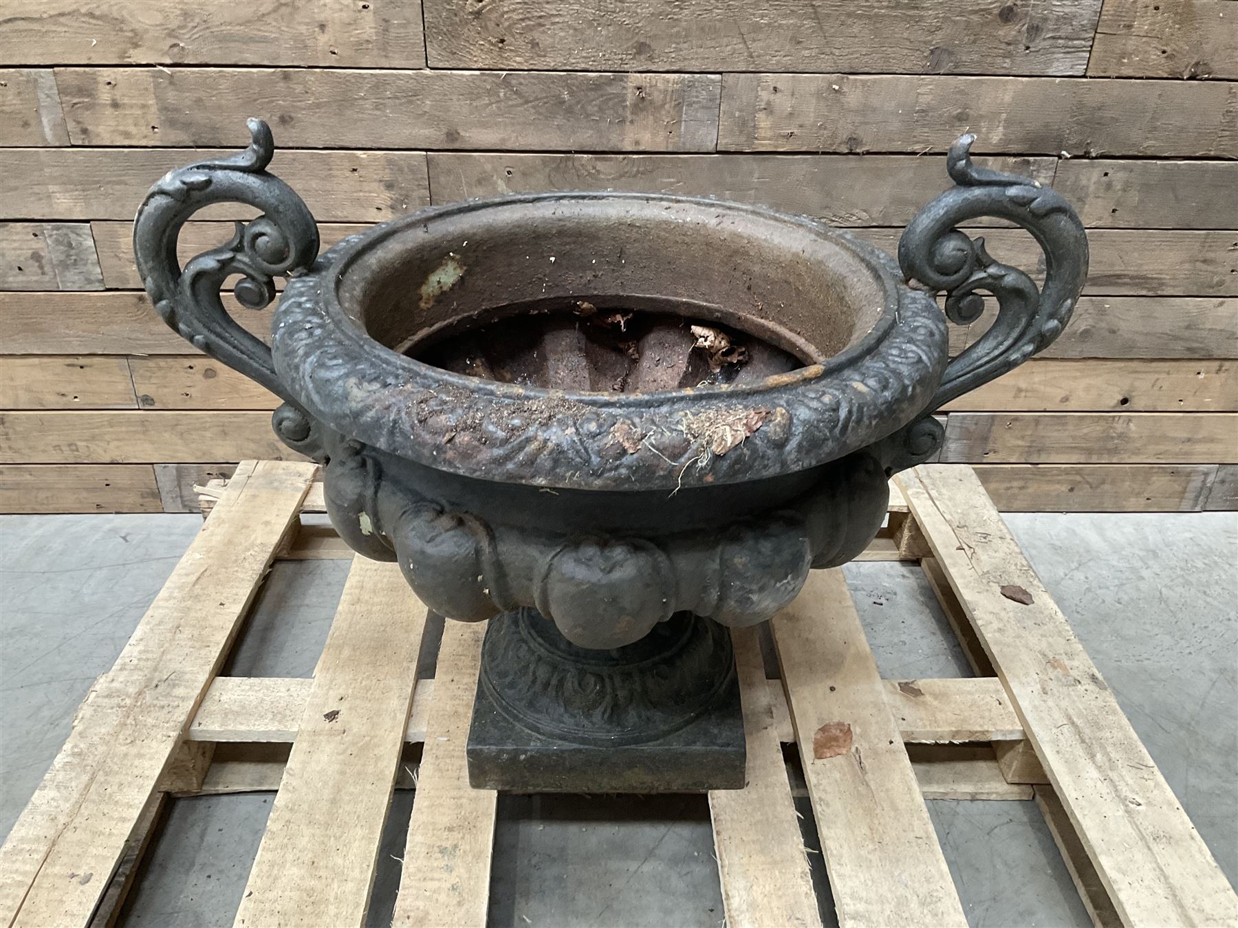 Victorian design ornate cast iron centrepiece urn, featuring two handles, raised on footed base