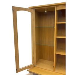 Light oak wall display cabinet, fitted with two glazed doors enclosing illuminated cupboards, above three drawers and two cupboards
