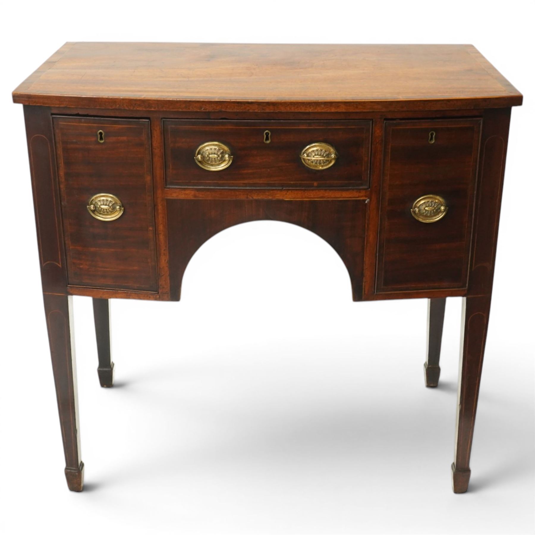 Small late 18th century inlaid mahogany sideboard, with bow fronted top with crossbanded edge, central drawer flanked by a drawer each side, kneehole cut out, raised on square tapering supports terminating in spade feet