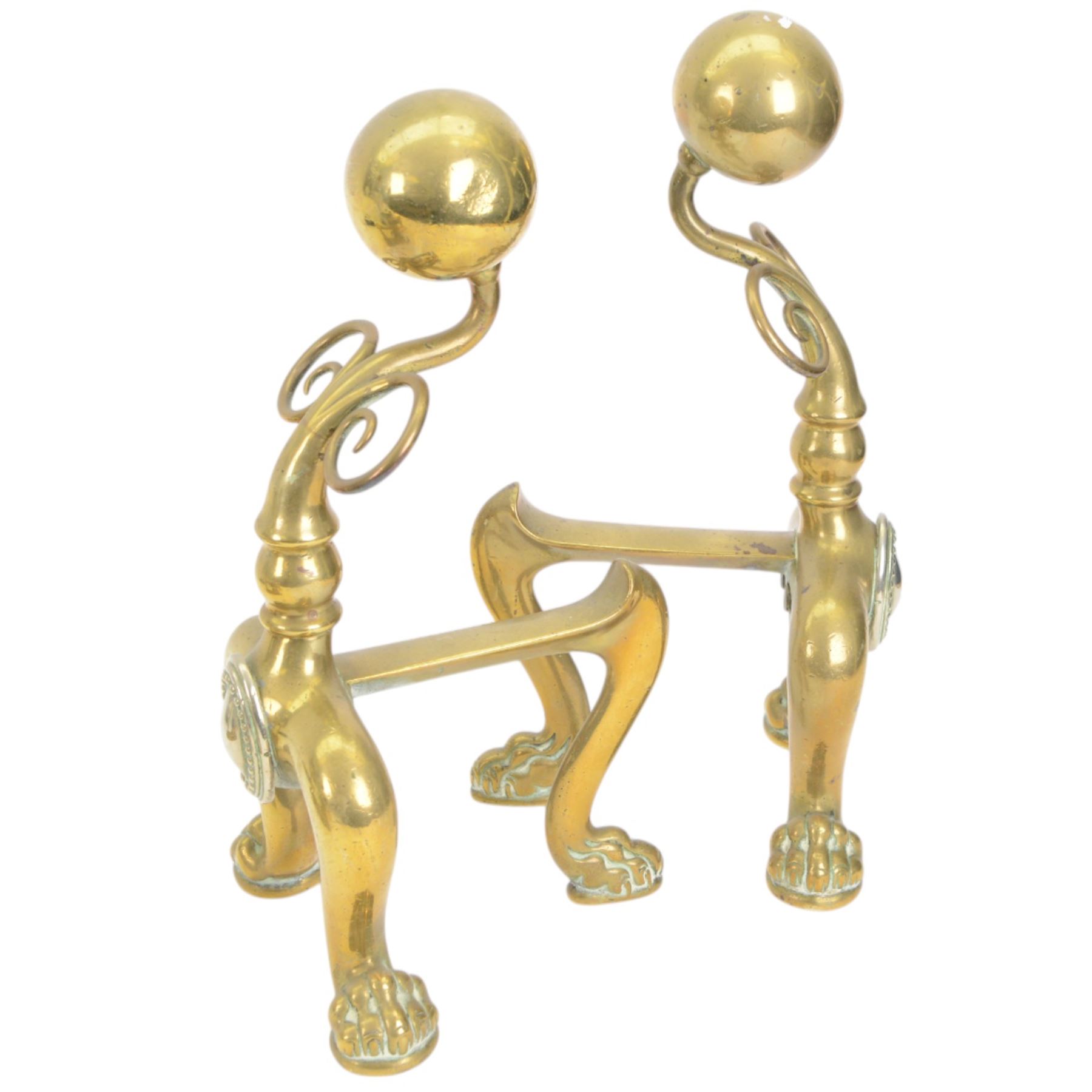 Pair of  Victorian brass fire dogs, decorative brass ball roundels to tops, with a silvered cartouche to the front, raised upon paw feet, together with two other fire dogs, largest H36cm 