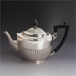 Victorian silver four piece tea service, comprising coffee pot, teapot, twin handled open sucrier and milk jug, all of oval part fluted form and engraved with initial to body, the coffee pot on oval stepped foot, coffee pot and teapot with ebonised wooden finials, hallmarked Elkington & Co, Birmingham 1888