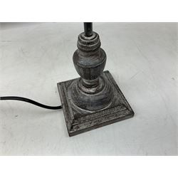 Table lamp, with a thin central stem upon a square stepped base, natural linen shade