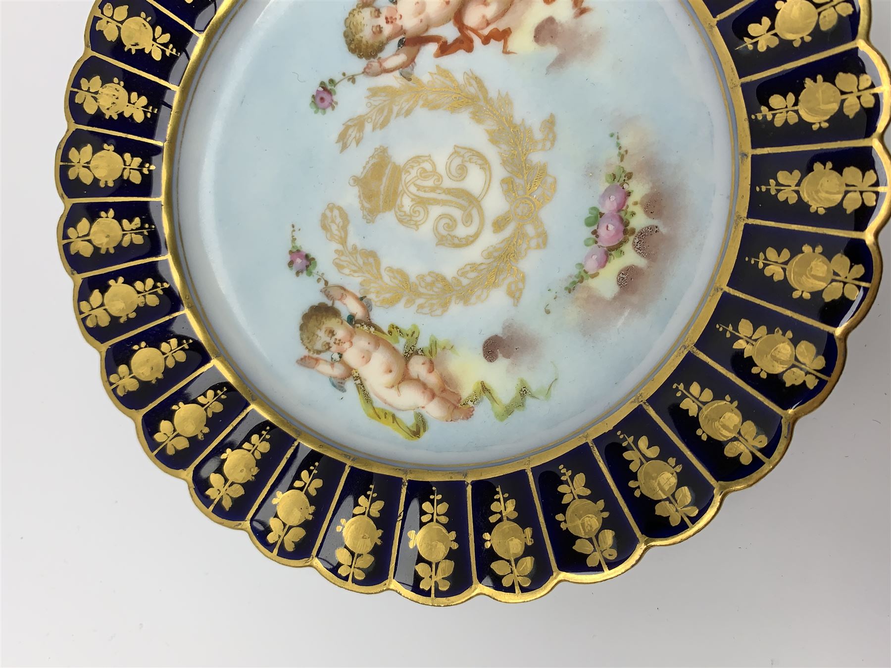 Mid 19th century Sevres Louis Philippe period porcelain cabinet plate, decorated with central Louis Philippe crowned monogram flanked by two cherubs, within cobalt gilt detailed border, with date mark for 1846, red inventory mark for Chateau des Tuileries, and blue monogram mark , D14.5cm