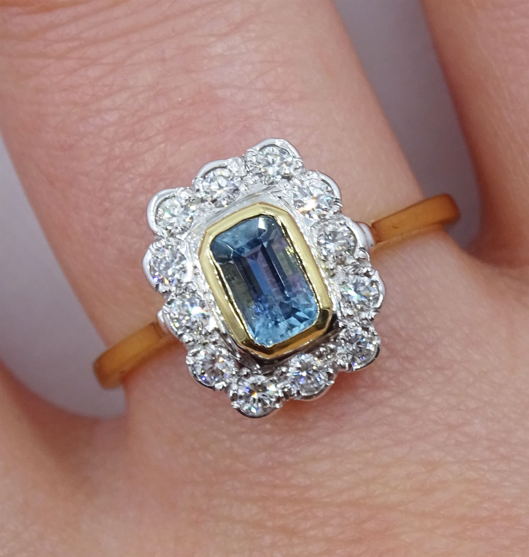 18ct gold emerald cut aquamarine and round brilliant cut diamond cluster ring, hallmarked, aquamarine approx 0..60 carat, total diamond weight approx 0.30 carat