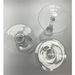 Three Whitefriars Royal Commemorative glasses, comprising two examples with bucket bowls etched with Royal ciphers and dates, upon baluster stems with internal tears and circular feet, one marked beneath W T Wilson no1080, the other G Baxter no 86; and a third example with funnel bowl also etched with Royal cipher and date, upon a baluster stem with internal tear and circular foot, marked beneath G Baxter No 218, H23.5cm.