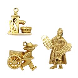 Three 9ct gold gold pendant/charms including Moses and the ten commandments, wishing well and a man pulling a cart, all hallmarked