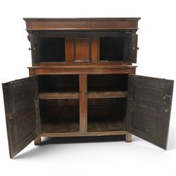 Early 18th century oak court cupboard, the projecting cornice carved with initials 'WKIW' and dated 1718 with turned terminals, fitted with two recessed panelled cupboard doors, large cupboard to base, raised on stile supports