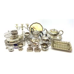 A group of assorted silver plate, to include various tea wares, three piece pierced cruet set, small candelabra, toast rack, pair of candlesticks, warming dish, etc. 