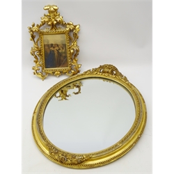  18th/ 19th century Continental giltwood frame, rectangular plate with beaded surround and openwork acanthus leaf scroll frame, with hand coloured engraving, H31cm x W20cm and a 19th century oval gilt gesso mirror, scroll cresting and beaded border (2)  