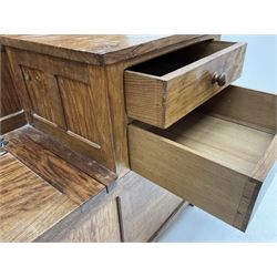 'Acornman' figured oak telephone table, panelled back above hinged seat and two drawers, panelled sides and front, all over adzing, by Alan Grainger of Brandsby, York