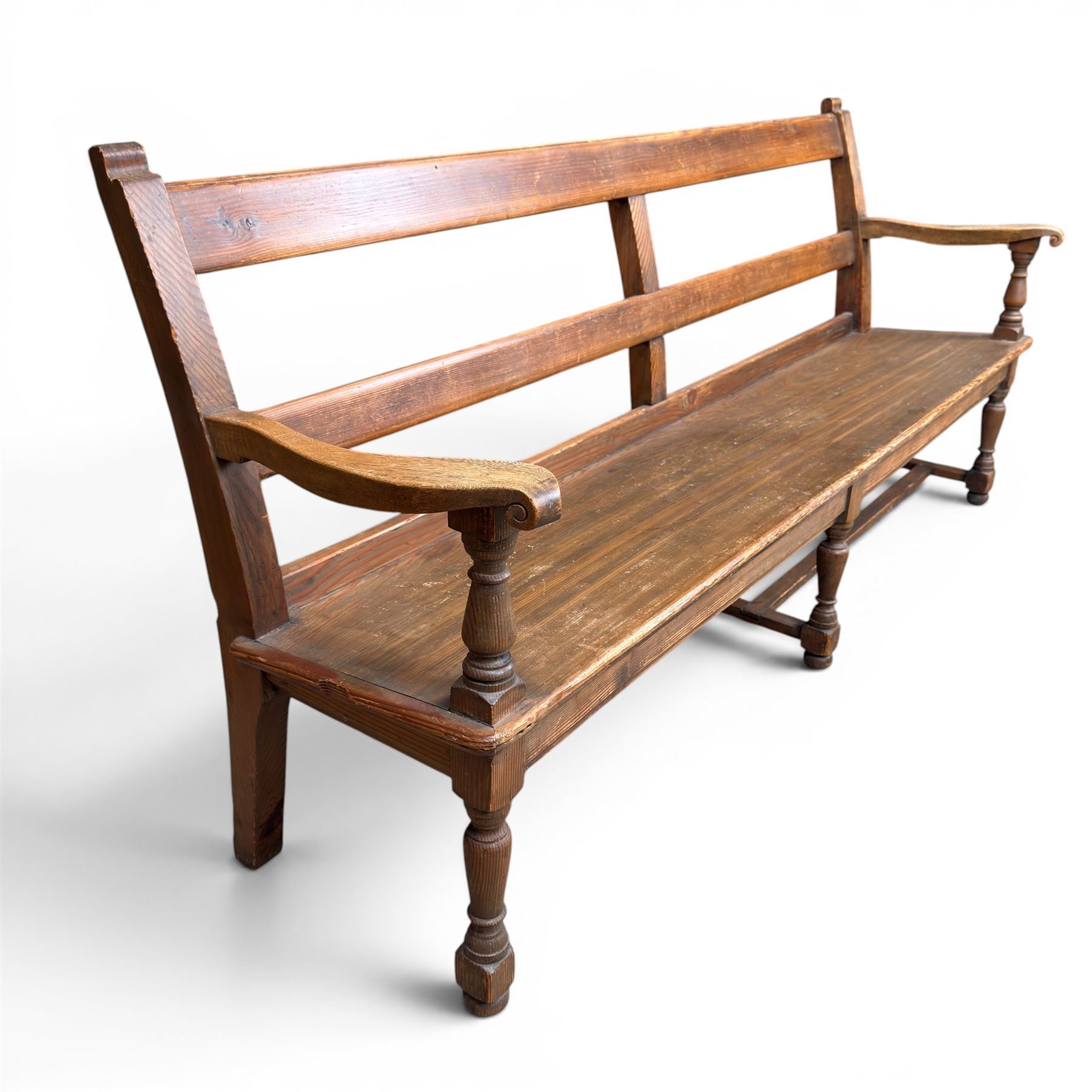 Early 20th century pine and oak bench seat, stained pine rail back frame with shaped oak arms