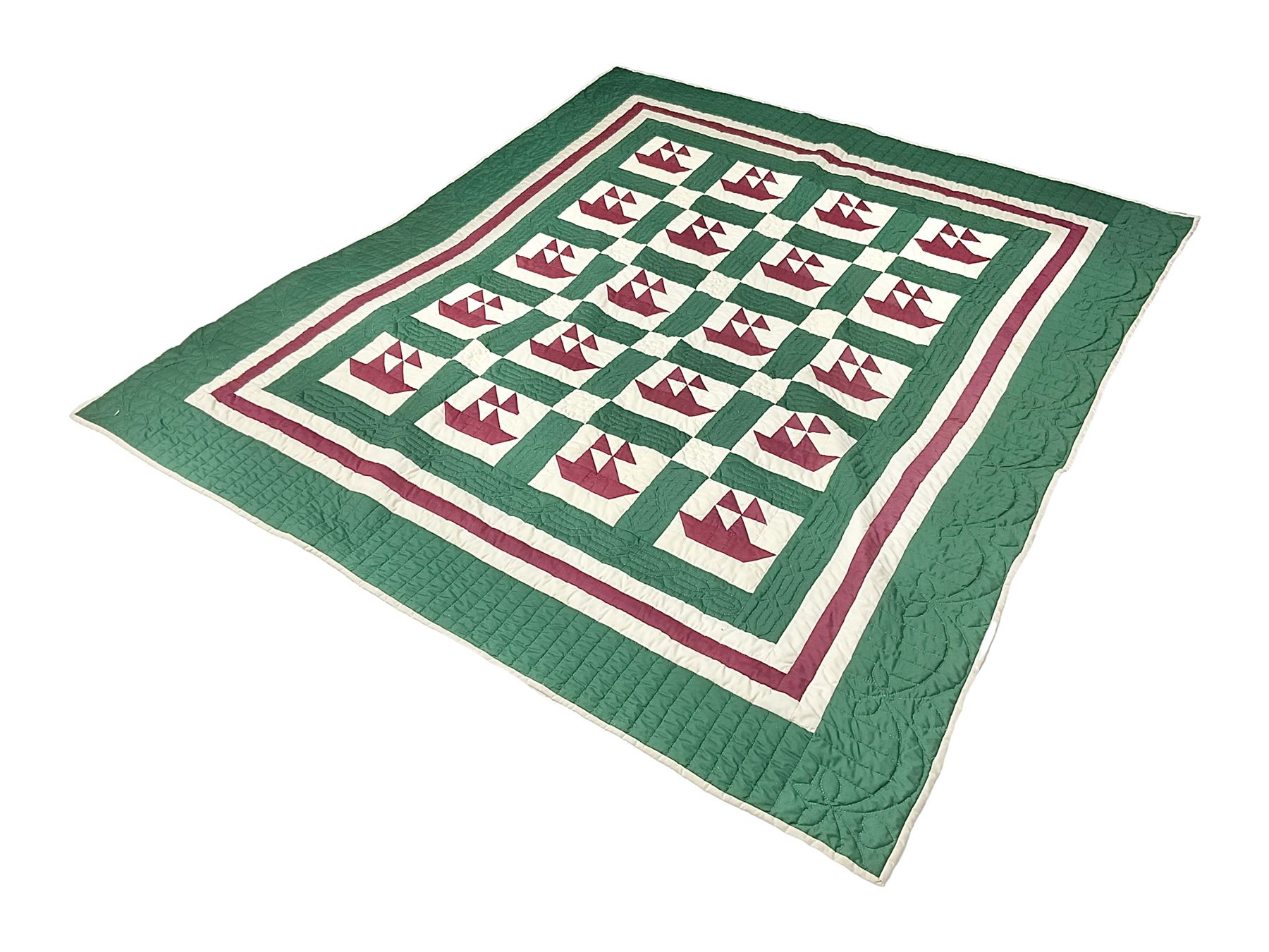20th century quilt, with repetitive ship design to the centre within a cream red and green boarder, 227cm x 222cm