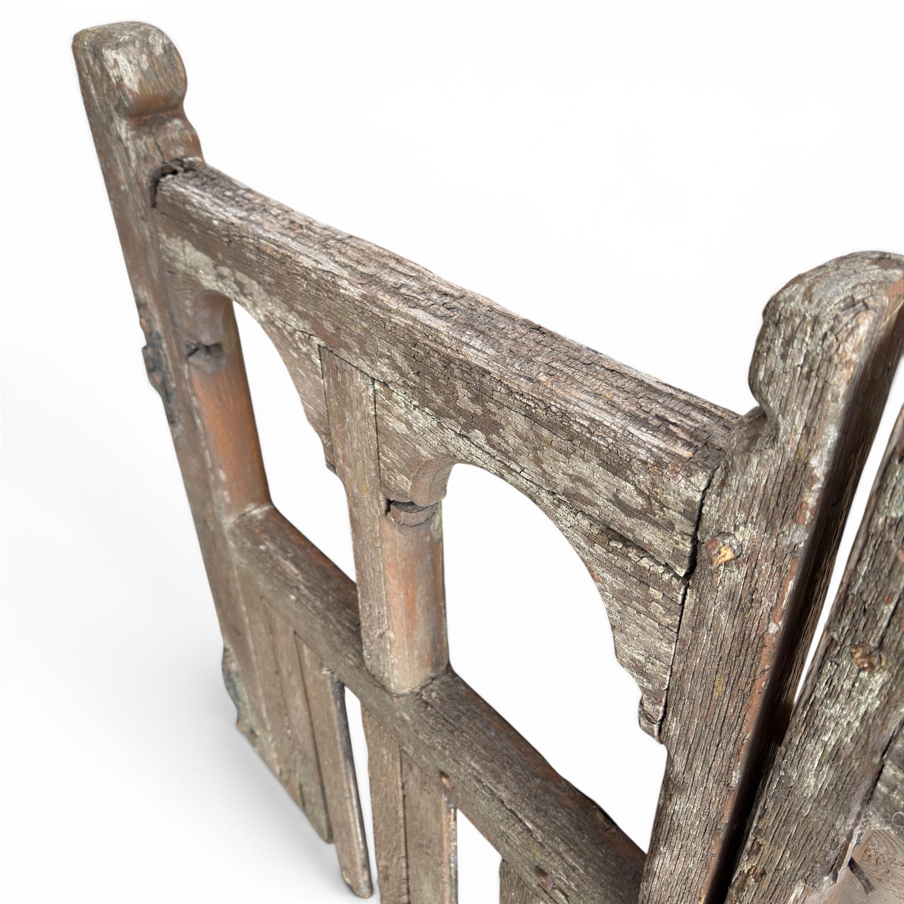 Pair of 19th century weathered wooden ecclesiastical church gates, the cresting rail over four pierced arches with slatted lower section, fitted with heavy cast iron hinges, latch and fittings