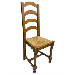 Oak extending dining table with elegant scrolled shaped double pedestal base and scrolled feet; together with a set of eight ladder back chairs with rush seats ((9) table closed 228x95x79cm chairs 106x38x44cm 