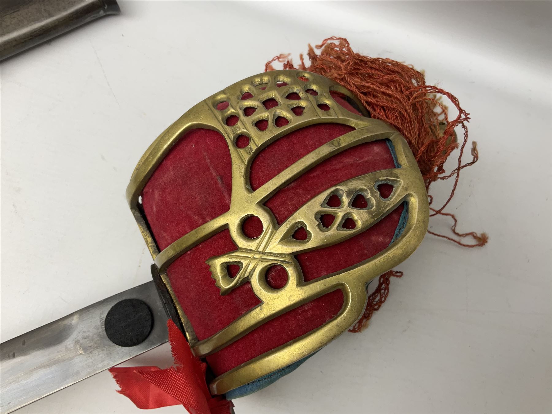 Reproduction Scottish officers basket hilt broad sword, the brass basket pierced with heart-shaped motifs lined with red lining, together with a reproduction Japanese Katana sword, longest L110cm