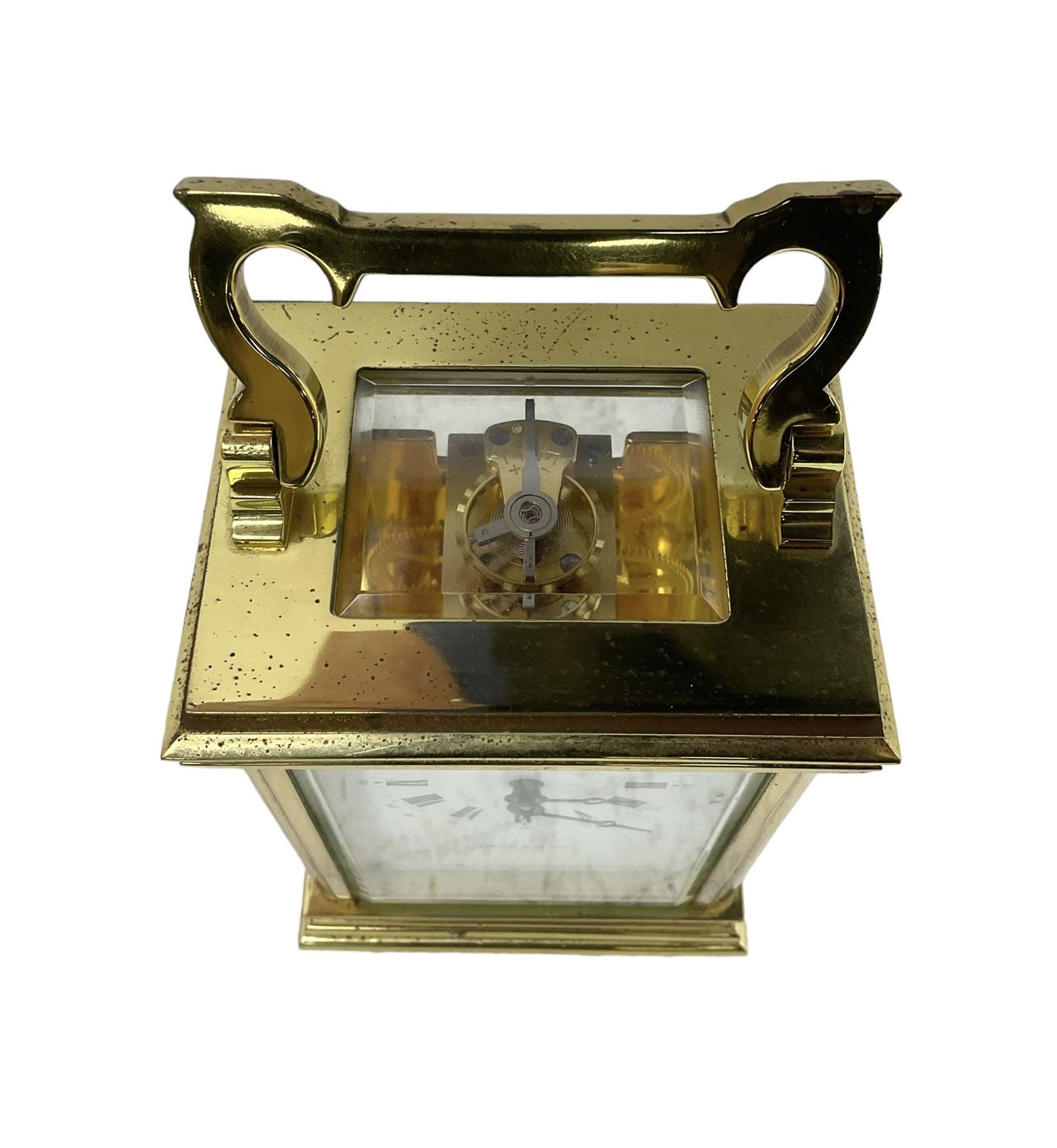 English - late 20th century 8-day carriage clock by Taylor & Bligh, in an Anglaise case with a rectangular handle, bevelled glass panels and enamel dial with Roman numerals, minute markers and steel moon hands, timepiece spring driven movement with a jewelled lever platform escapement. With key.
