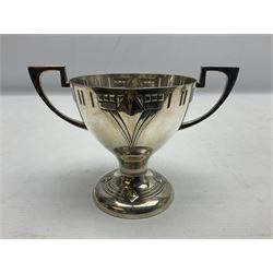 Pair of early 20th century WMF silver plated twin handled pedestal trophies, the bowl-shaped cups with Art Nouveau stylised relief decoration and pierced rim raised upon circular spreading foot similarly decorated, with stamped marks beneath, H12cm