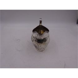 George III silver cream jug, of helmet form, with C scroll handle and a band of engraved strapwork decoration and monogrammed initials to body, hallmarked London 1802, maker's mark SA probably Stephen Adams I, including handle H10.4cm