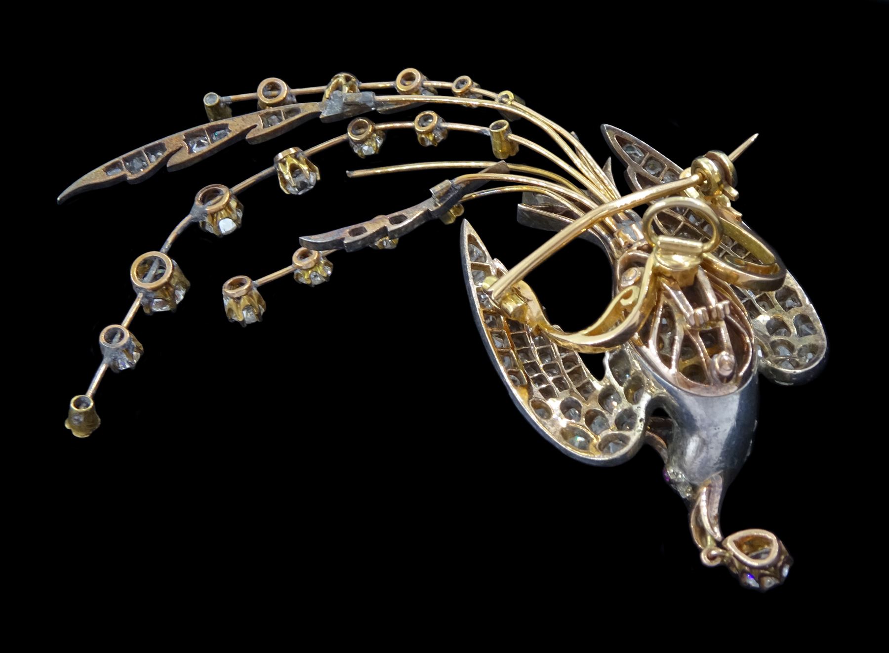 Victorian diamond swallow aigrette brooch, the gold backed silver swallow in flight set with old cut and rose cut diamonds, with cabochon ruby eyes, holding a pear cut diamond of approx 0.25 carat, to an old cut diamond spray tail of approx 1.95 carat, total diamond weight approx 4.00 carat
