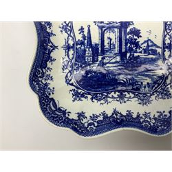 Late 18th century Worcester dessert dish, of square form with shaped rim, with underglaze blue printed decoration depicting a figure fishing at the waters edge before a ruined temple and obelisk, within scrolling inner border, and Fitzhugh type outer border, with disguised numeral mark beneath, D24cm
Footnote: Pieces of this type with this series of marks were formerly believed to have been produced by the Caughley factory
