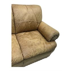 Contemporary three-seat sofa, upholstered in stitched brown leather with brass studwork decoration, rolled back and arms, raised on turned supports