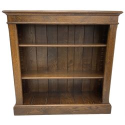 Traditional oak open bookcase, rectangular moulded top over three adjustable shelves, on moulded plinth base