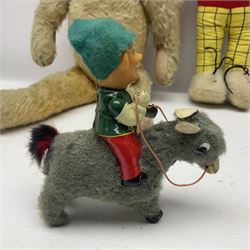 Deans Rag Book Mickey Mouse soft toy, circa 1930's, black velveteen head and body, with cream face and hands, red shorts and yellow felt shoes with leather soles, marked Reg. No. 750811 to neck H20cm; mid-20th century woodwool filled plush covered teddy bear with revolving head, applied eyes, vertically stitched nose and mouth and jointed limbs H52cm; soft toy figure of Rupert Bear; and Japanese clockwork tin-plate and plush covered mechanical toy of a gnome riding a donkey (4)