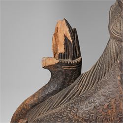 Burmese carved temple guardian figure, depicted seated with carved flame details, H52cm 