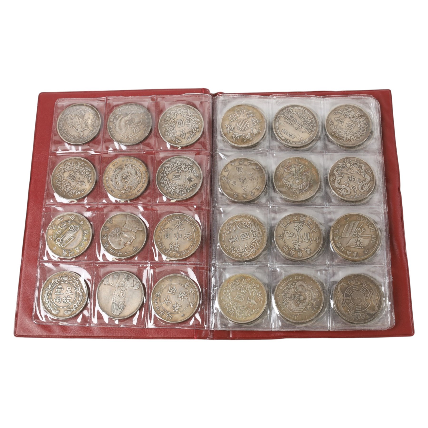 Seventy-two restrike Chinese coins, in a red album