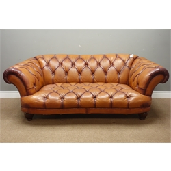  Two seat Chesterfield shaped sofa, deep curved seat upholstered in deeply buttoned antique finish tan leather, W207cm, D105cm  