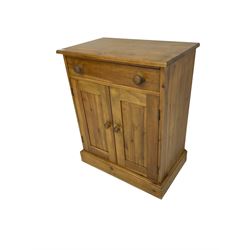 Pine cupboard, rectangular top over single drawer and two panelled doors enclosing shelf