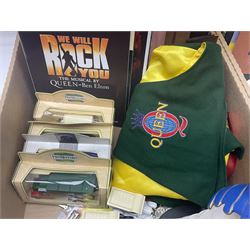 Mostly Queen and Freddie Mercury interest items, including pin badges, newspaper cuttings, diecast 'promotional' vehicles, special edition Pop Rocks figure of Freddie Mercury, VHS tapes, two charity certificates signed by Brian May and Roger Taylor, poster etc, in two boxes 