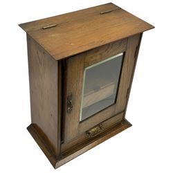 Early 20th oak smokers cabinet with the single glazed door to fitted interior having a single draw and pipe rack, H40cm pipe rack, H39cm