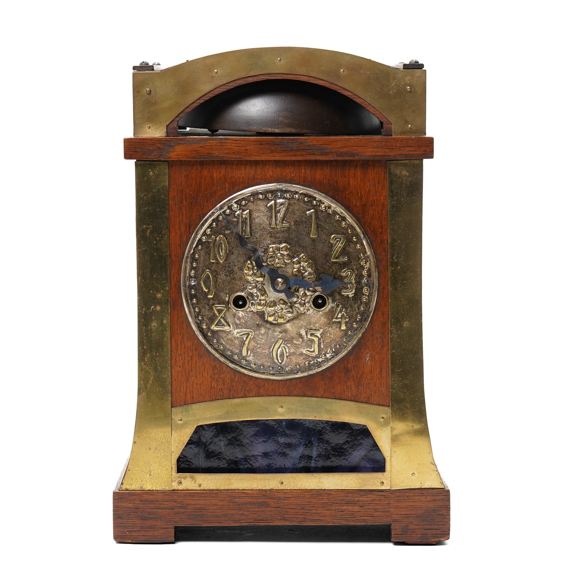 Arts and Crafts oak and brass mounted mantel clock, Hamburg-American Clock Company (HAC), for Liberty & Co, the eight day movement with bell strike, repousse dial with Arabic numerals H36.5cm

  