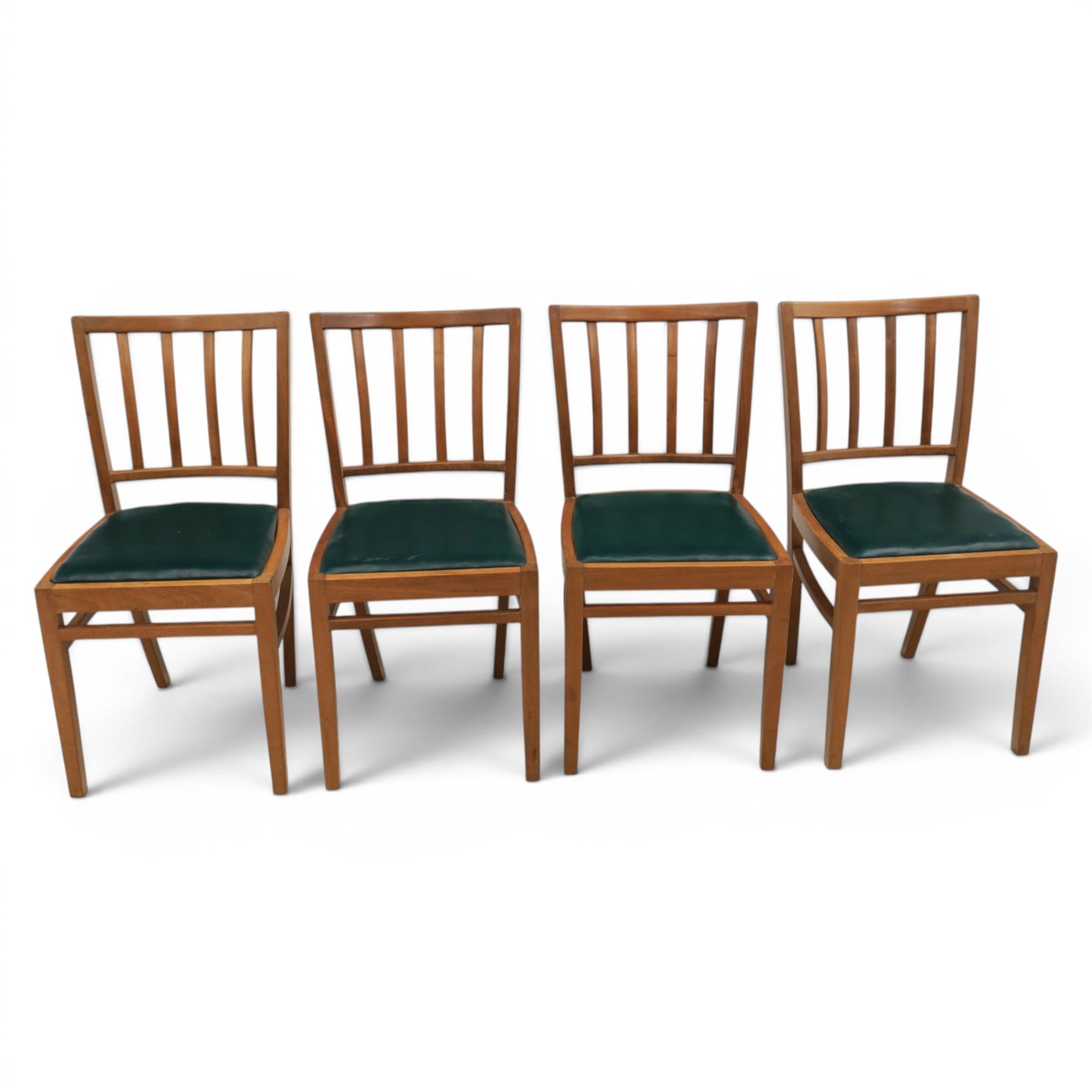 Mid 20th century teak extending dining table, together with eight teak chairs with green leather seats, extends to 154cm
