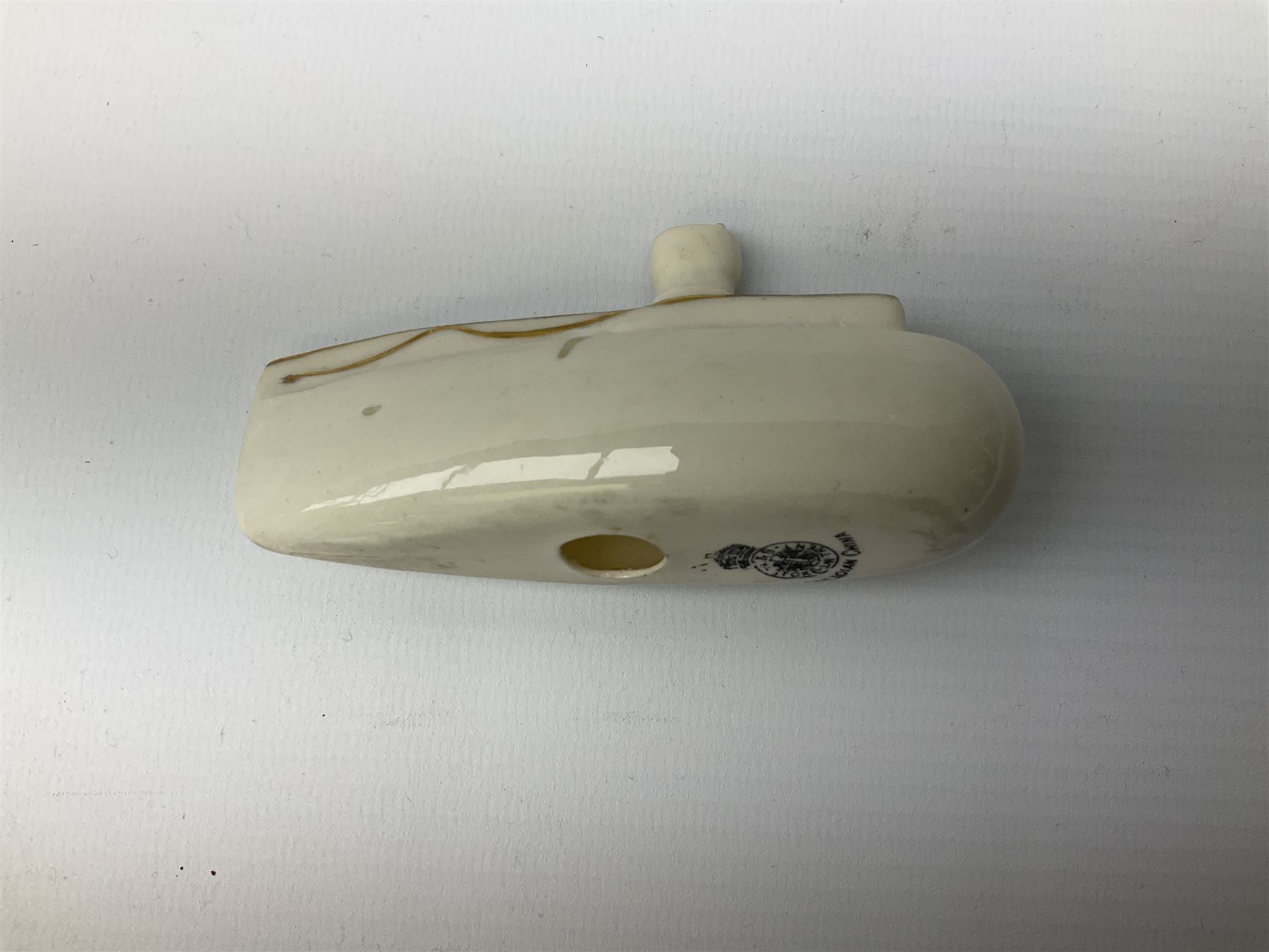 Three pieces of crested ware, comprising grenade detailed 'The Mills Hand Grenade' with Filey Crest, marked beneath Grafton China, a cannon with crest banner detailed 'Sterlini Oppidvm', marked beneath W H Goss, and a submarine with Tunbridge Wells crest, marked beneath Arcadian China 