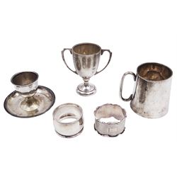 Group of silver, comprising twin handled trophy cup, christening mug, egg cup and two napkin rings, all hallmarked