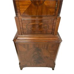 John Morgan of Aberystwyth - fine George IV mahogany 8-day longcase clock c1820, with a raised swan necked pediment, ball and eagle finial and deep inlaid frieze beneath, square hood door with a glazed circular wooden bezel and canted corners, long trunk with reeded quarter columns and a wavy topped door, rectangular plinth on bracket feet, circular painted dial with Roman numerals, minute track, makers name, and brass stamped hands, rack striking four pillar movement with a recoil anchor escapement, striking the hours on a bell. With weights and pendulum. 
John Morgan is recorded as working in Aberystwyth 1816-35. 