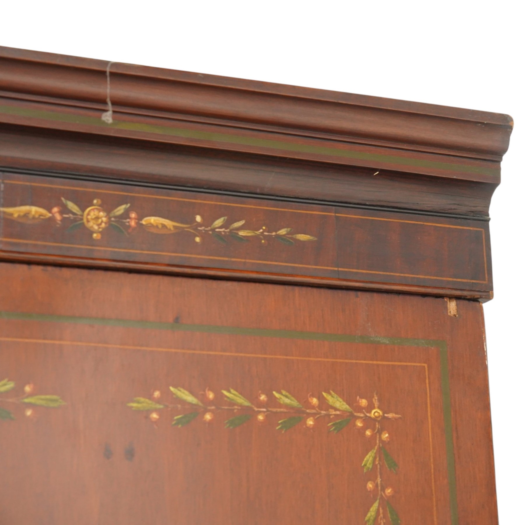 19th century French Louis XVI design mahogany and polychrome painted gentleman's press wardrobe - projecting cavetto cornice with urn and bellflower painted frieze, the twin doors with classical figural medallions surmounted by urns and festoon decoration with scrolling acanthus leaves, enclosing five sliding trays, the base fitted with two short over three long cock-beaded drawers, the facias painted with interlocking swags and garlands of bouquets with recumbent lion brass handle-plates, lower reeded edge on turned feet