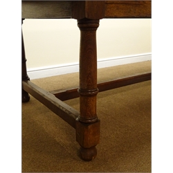  Large oak refectory dining table, panelled top on ring turned supports joined by an H stretcher, L289cm, H76cm, D107cm  