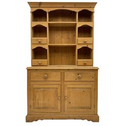 Solid pine dresser, raised plate rack fitted with small drawers over two drawers and double cupboard, plinth base